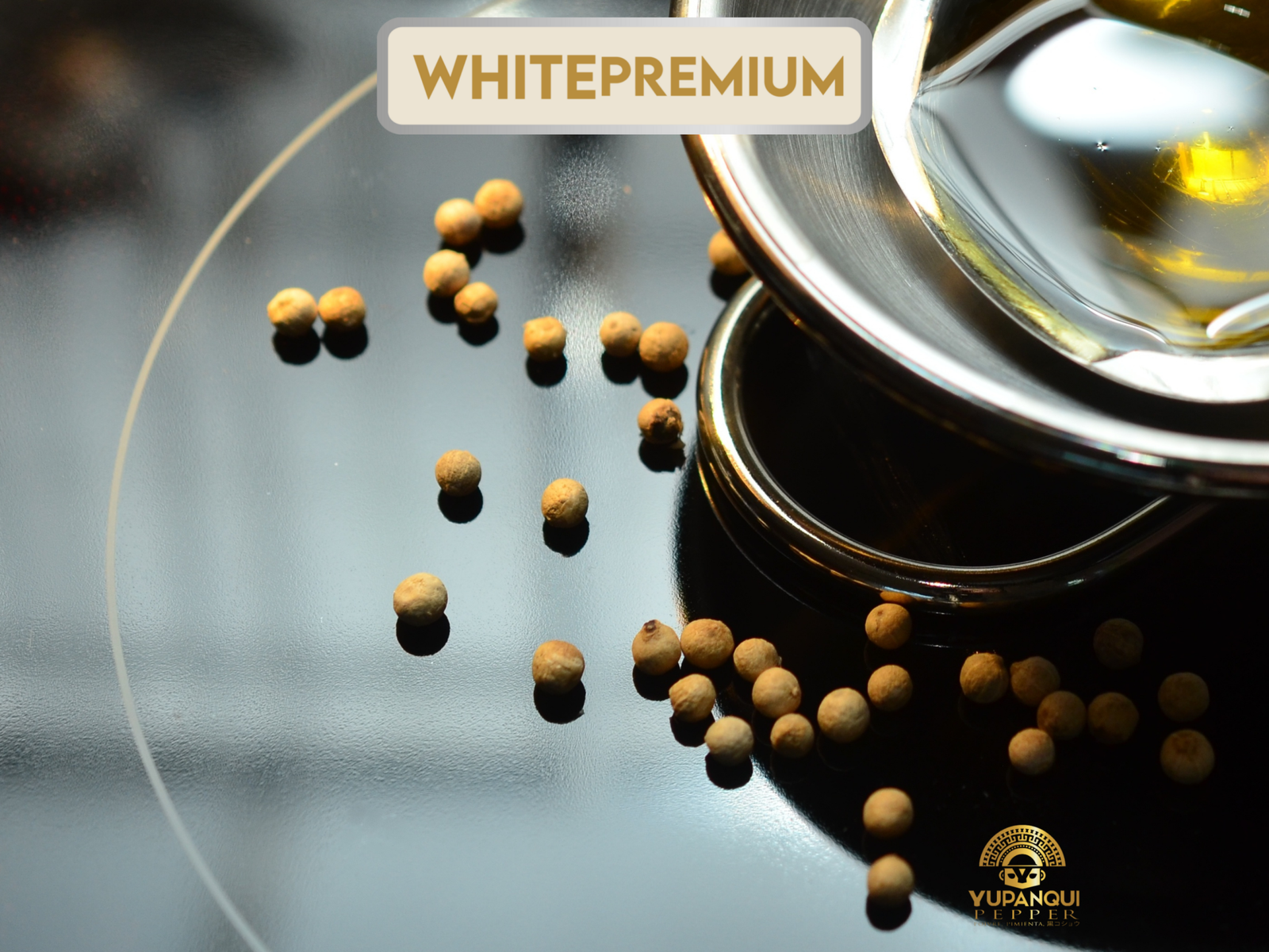 Yupanqui White Premium whole white peppercorns beside stacked tableware