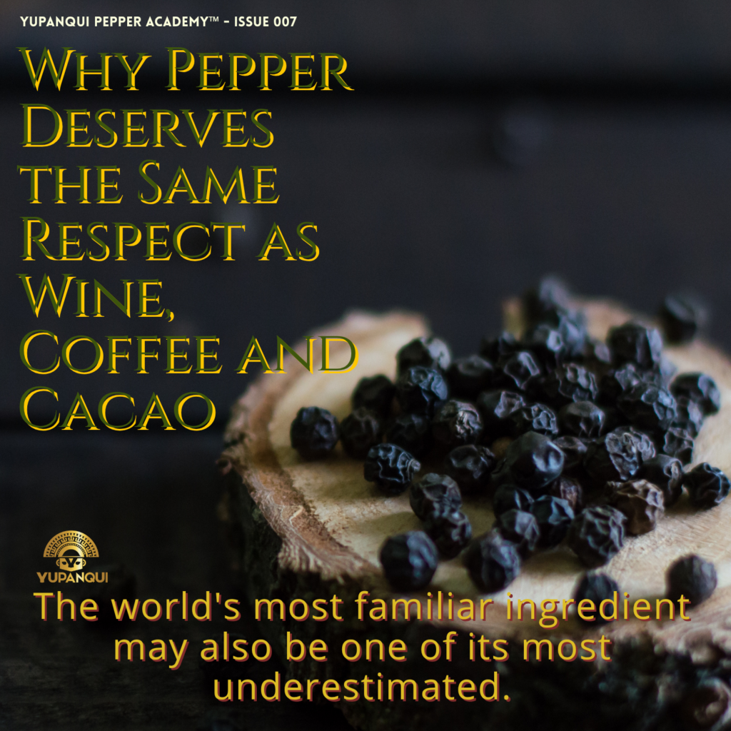 Why pepper deserves the same respect as wine, coffee and cacao: whole black peppercorns on a wood slice.
