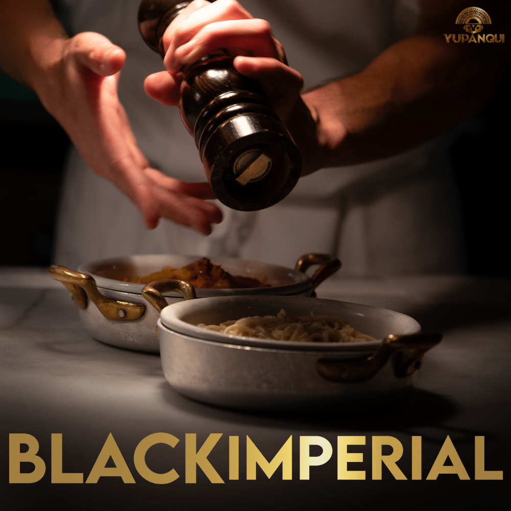 Freshly grinding Yupanqui Black Imperial whole black peppercorns over an everyday meal
